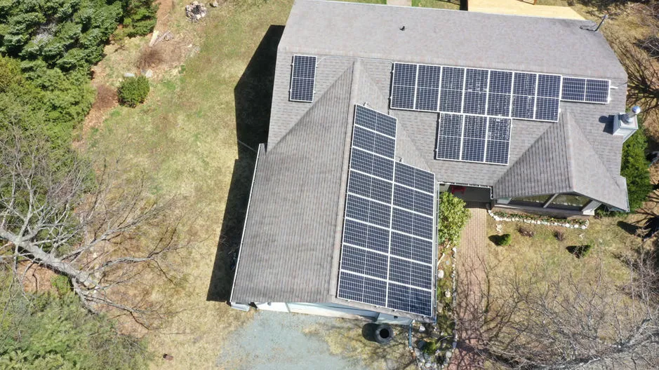 Aerial view of a residential rooftop solar panel installation in Nova Scotia