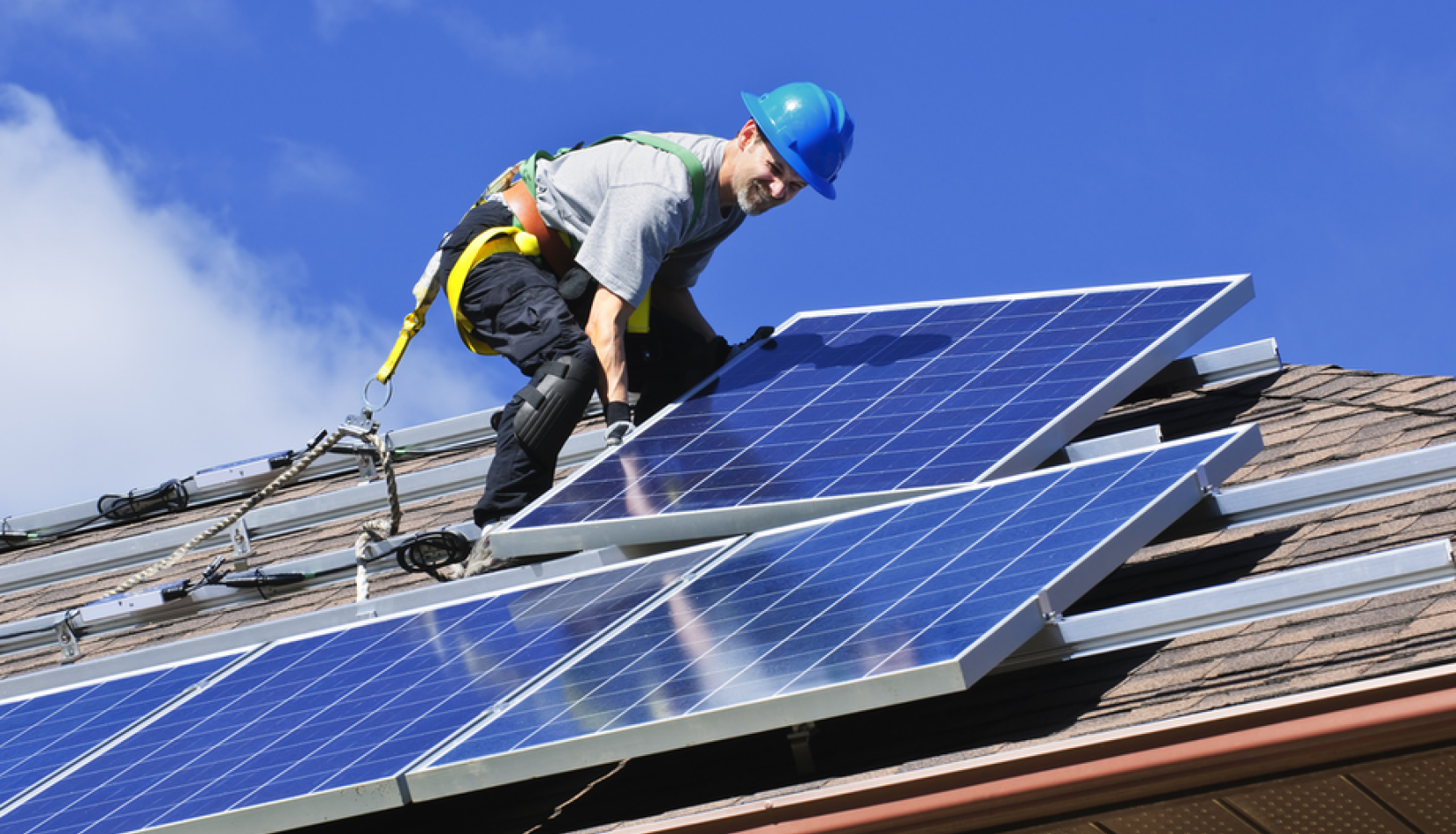 OYO Energy technician installing Pion Solar racking on a residential roof