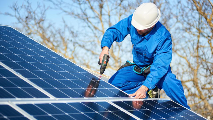 OYO Energy technician installing rooftop solar panels in Nova Scotia