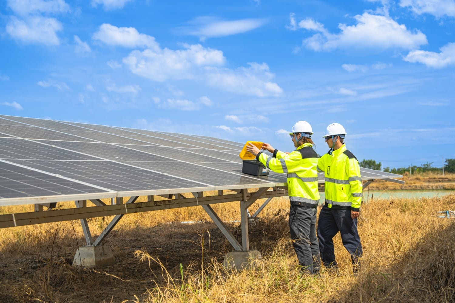 OYO Energy technicians inspecting a ground mount solar array on the South Shore